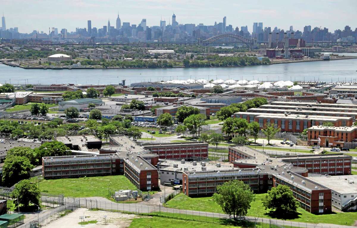 FILE- This June 20, 2014 file photo shows the Rikers Island jail with the New York skyline in the background. Over the past five years, there have been three deaths in New York City's jails in which inmates were alleged to have been fatally beaten by guards. Yet in none of those cases was anyone ever charged with a crime. (AP Photo/Seth Wenig, File)