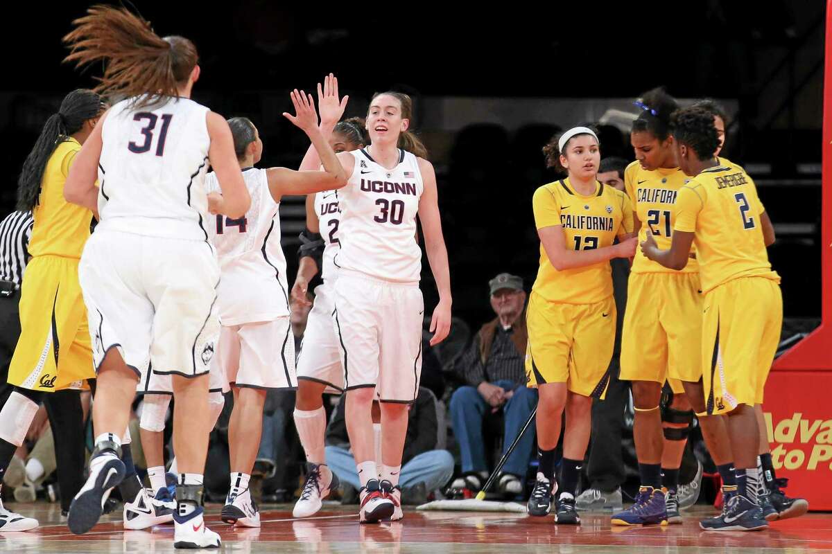 UConn’s Breanna Stewart (30) celebrates with teammates after drawing a foul during the second half of Sunday’s game against California. The Huskies won easily 80-47.