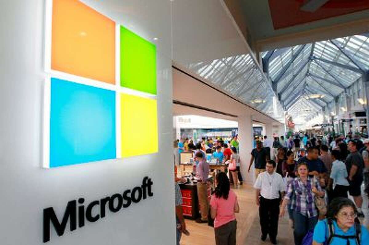 FILE - In this Thursday, Aug. 23, 2012, file photo, a new Microsoft Corp. logo, left, is seen on an exterior wall of a new Microsoft store inside the Prudential Center mall, in Boston. Microsoft is updating its Windows software for cellphones to accommodate larger devices and make it easier for motorists to reduce distractions while driving. (AP Photo/Steven Senne, File)
