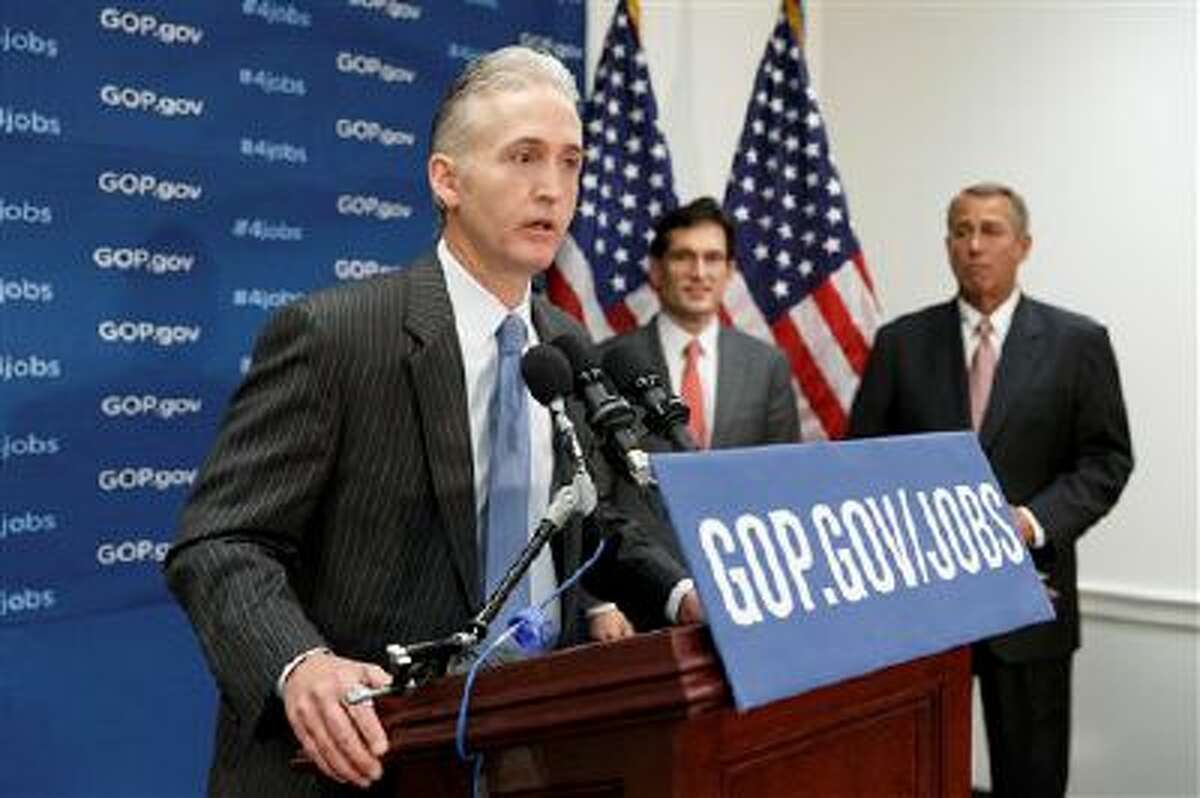 Rep. Trey Gowdy, R-S.C., joins Speaker of the House John Boehner, R-Ohio, right, and House Majority Leader Eric Cantor, R-Va., as he speaks to reporters about a bill he has sponsored that charges President Barack Obama with failing to enforce federal laws, at the Capitol in Washington, Wednesday, March 12, 2014. (AP Photo/J. Scott Applewhite)