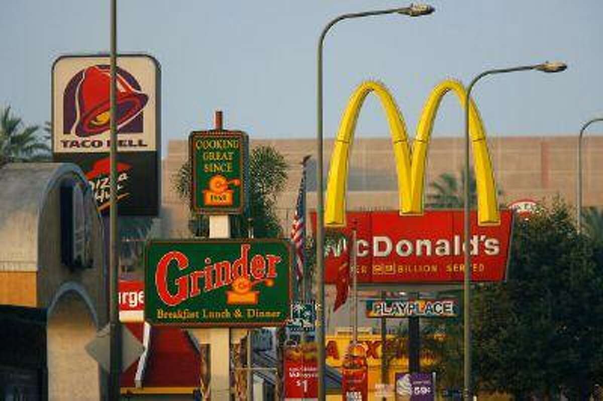 Fast-food restaurants signs line a street July 24, 2008 in the South Los Angeles area of Los Angeles, Calif.