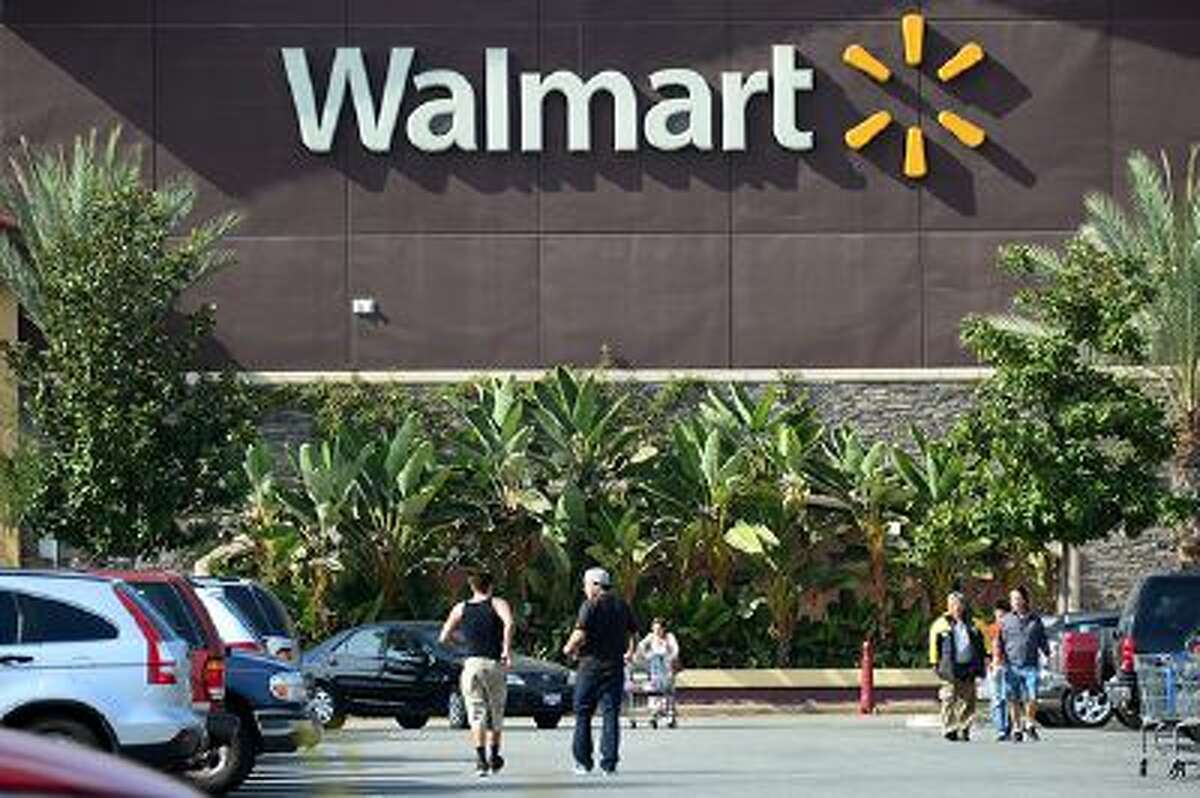 Shoppers are seen outside a Walmart store in Rosemead, California on January 29, 2014, on a day the world's largest retailer said it will tighten inspections on its suppliers in China after it was forced to recall donkey meat products that had been found to contain fox. The US company said it would also change its rules in China to ensure that meat shipments are properly documented before they hit the shelves. AFP PHOTO FREDERIC J. BROWN (Photo credit should read FREDERIC J. BROWN/AFP/Getty Images)