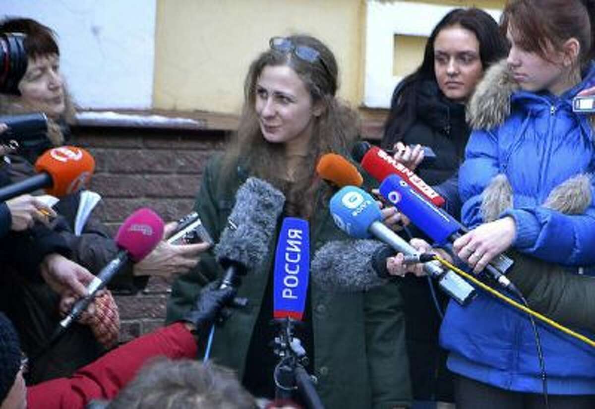 Maria Alekhina, second from left, a member of the Russian punk band Pussy Riot, speaks to the media after being released from prison on Monday, Dec. 23.