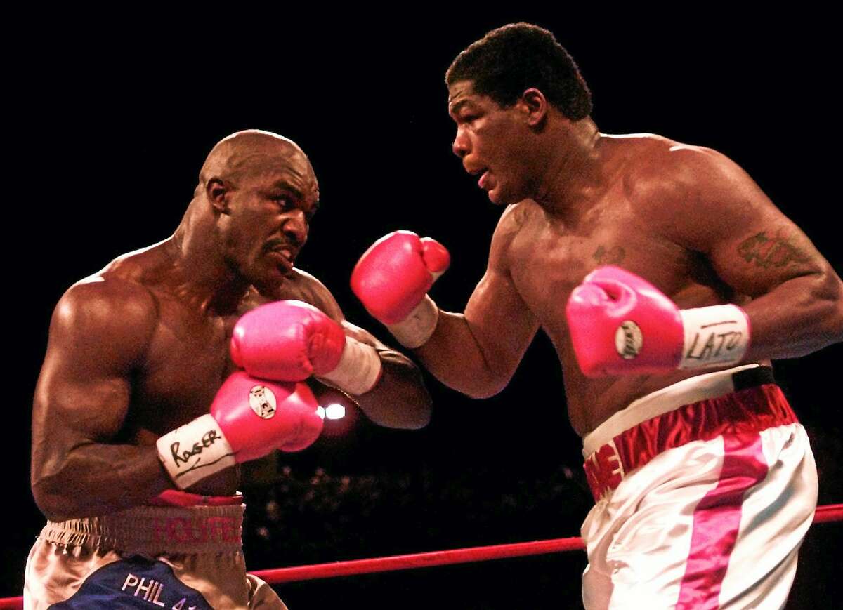 Heavyweights Evander Holyfield, left, and Riddick Bowe battle in the third round of their Nov. 4, 1995 fight at Caesars Palace in Las Vegas.