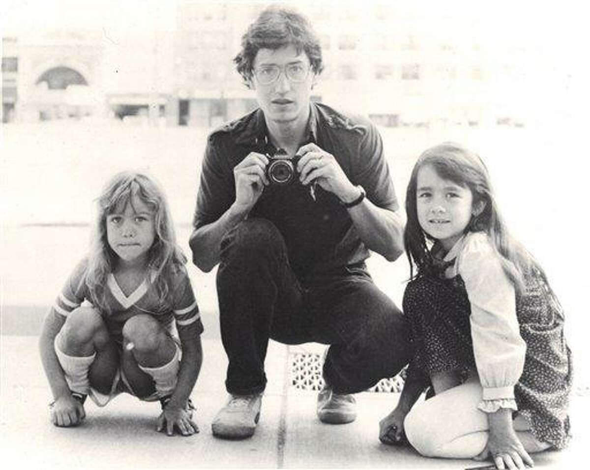 In this undated photo provided by Keely Walker Muse, her father journalist John Clay Walker poses for a portrait with his daughters Lannie, left, and Keely in Minneapolis, Minnesota. Mexican drug lord Rafael Caro Quintero was sentenced to 40 years in prison for the 1985 murders of Walker, his friend Alberto Radelat, and DEA agent Enrique "Kiki" Camarena, among other crimes. According to witnesses interviewed by DEA agents hunting for Camarena's killers, the cartel had mistaken Walker and Radelat for undercover agents. Caro Quintero walked free in August 2013, 12 years early after a local appeals court overturned his sentence for three of the murders. Walker was a Marine who was twice wounded by land mines in Vietnam and then worked as a newspaper journalist before taking his family to Mexico so he could write his book in a place where his pension could stretch further. He and his wife were befriended by Radelat, a dentist looking at taking classes at the main university in Guadalajara. (AP Photo/Courtesy Keely Walker-Muse)