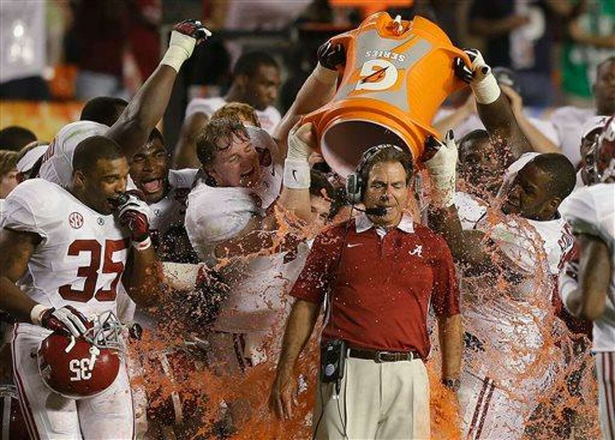 FILE - In this Jan. 7, 2013, file photo, Alabama head coach Nick Saban is doused with Gatorade in the final seconds of the BCS National Championship college football game against Notre Dame in Miami. Alabama will begin this season the way it ended the last two -- No. 1. Nick Saban and the two-time defending national champion Crimson Tide are top-ranked in The Associated Press preseason college football poll released Saturday, Aug. 17, 2013, as they try to become the first team to win three straight national titles. (AP Photo/Wilfredo Lee, File)