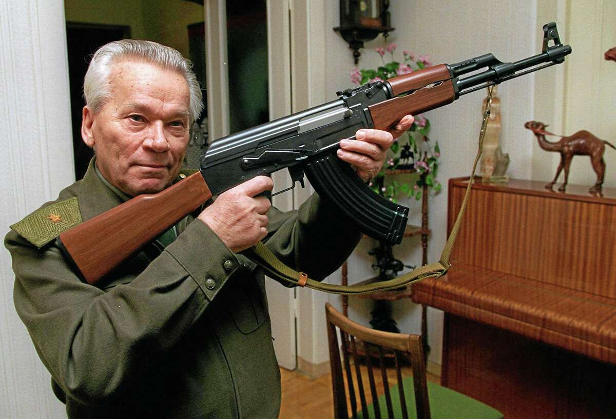 FILE- In this Wednesday, Oct. 29, 1997 file photo Mikhail Kalashnikov shows a model of his world-famous AK-47 assault rifle at home in the Ural Mountain city of Izhevsk, 1000 km (625 miles) east of Moscow, Russia. Kalashnikov, whose work as a weapons designer for the Soviet Union is immortalized in the name of the worldís most popular firearm, died Monday at the age of 94 in a hospital of the city of Izhevsk where he lived. The AK-47 has been favored by guerrillas, terrorists and the soldiers of many armies. An estimated 100 million guns are spread worldwide. (AP Photo/Vladimir Vyatkin, File)