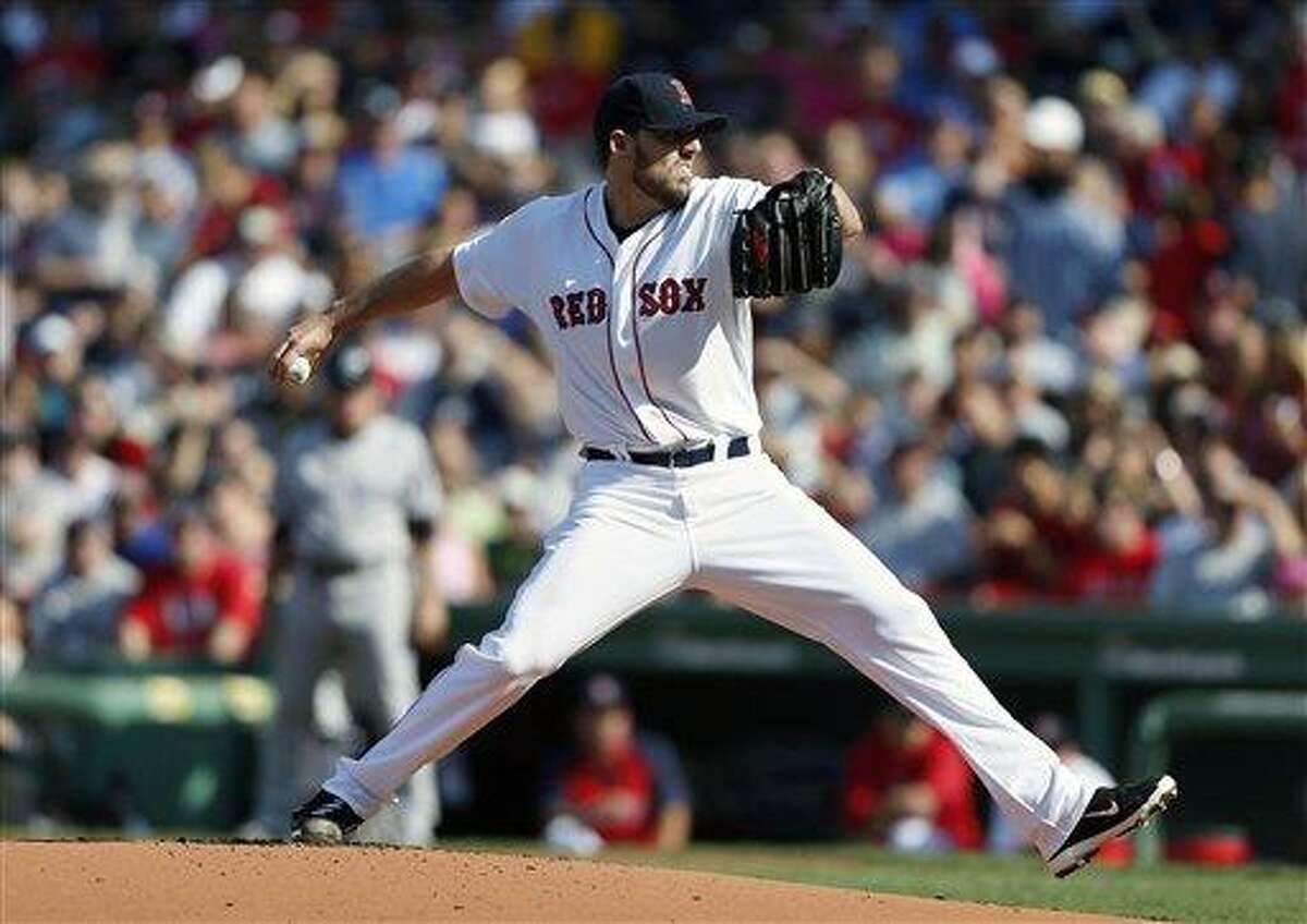 Boston Red Sox's John Lackey pitches in the first inning of a baseball game against the New York Yankees in Boston, Saturday, Aug. 17, 2013. (AP Photo/Michael Dwyer)