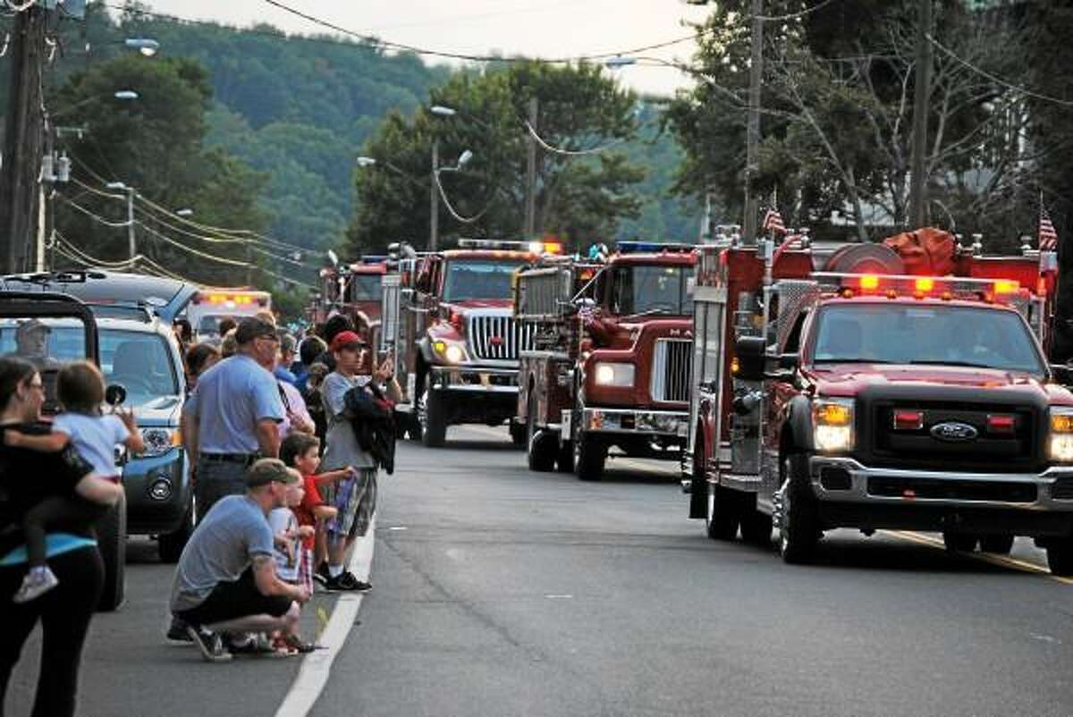 Dozens of fire departments from around Connecticut walked and drove the length of Winsted's Main Street. (Jessica Glenza-Register Citizen)