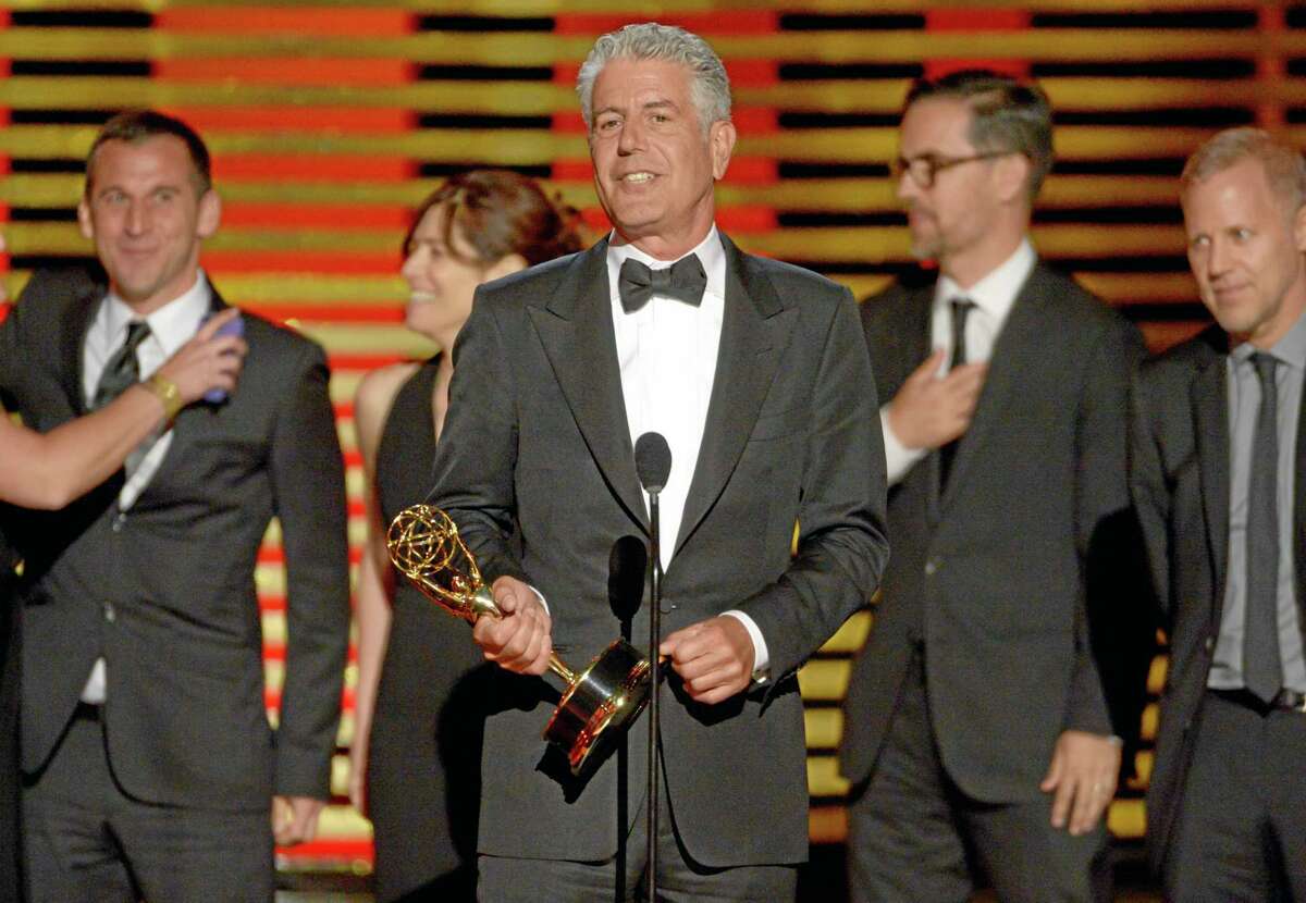 Anthony Bourdain and the team of “Anthony Bourdain: Parts Unknown” accept the award for outstanding informational series or special at the Television Academy’s Creative Arts Emmy Awards at the Nokia Theater L.A. LIVE on Saturday, Aug. 16, 2014, in Los Angeles.