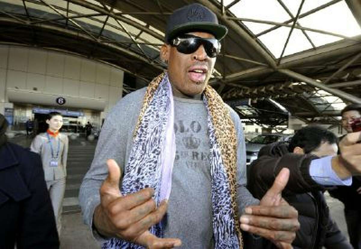 Former basketball star Dennis Rodman speaks to journalists upon arrival at the capital airport in Beijing from Pyongyang, North Korea.