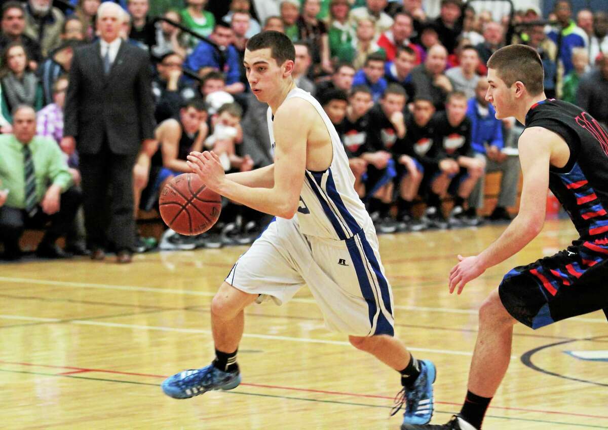 Lewis Mills’ Nate Cook drives to the lane in the Spartans 55-45 win. Cook scored 18 points in the win.