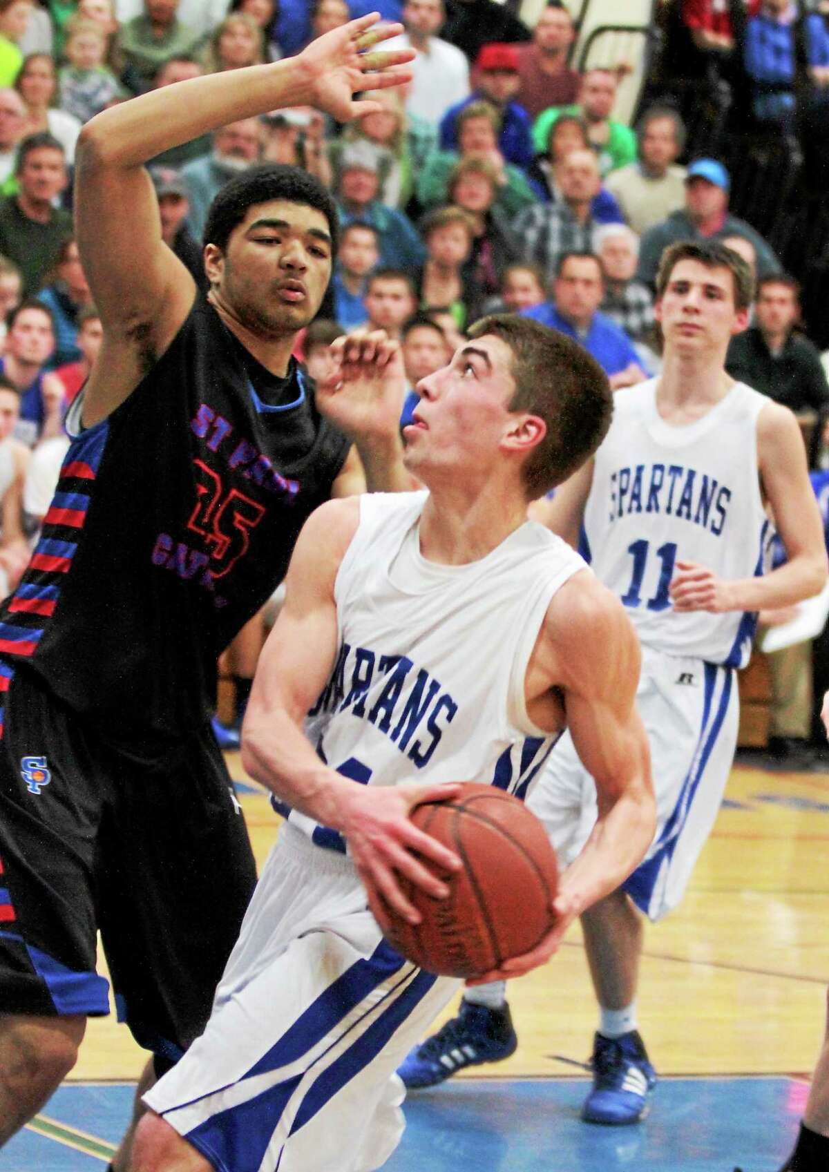 Lewis Mills’ Spencer Maloney looks to shoot during the Spartans 55-45 win over St. Paul.