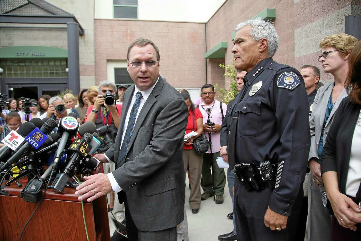 South Pasadena, Calif., police chief Arthur Miller, right, and South Pasadena Unified School District superintendent Dr. Geoff Yanz announce at a City Hall news conference Tuesday, Aug. 19, 2014, that the police has arrested two South Pasadena High School high school students suspected of planning a massacre at the school after investigators monitored their Internet activities. Miller said that school officials had heard about the plot and informed police, who determined the threat was credible. Police say the boys, ages 16 and 17, didn't have weapons but were researching automatic weapons and explosives, especially propane. (AP Photo/ Nick Ut )