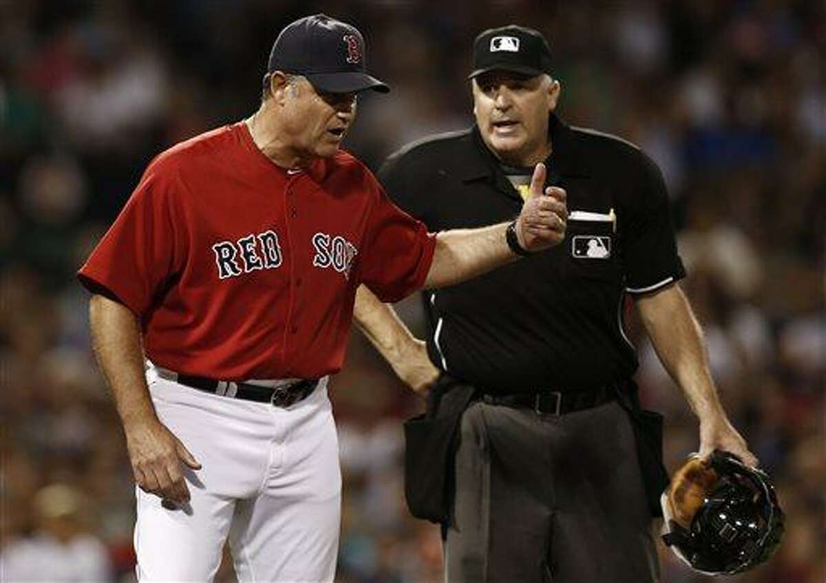 Boston Red Sox manager John Farrell argues with home plate umpire Bill Welke, who ruled that Mike Carp was not hit by a pitch during the seventh inning of a baseball game against the New York Yankees at Fenway Park in Boston Friday, Aug. 16, 2013. (AP Photo/Winslow Townson)