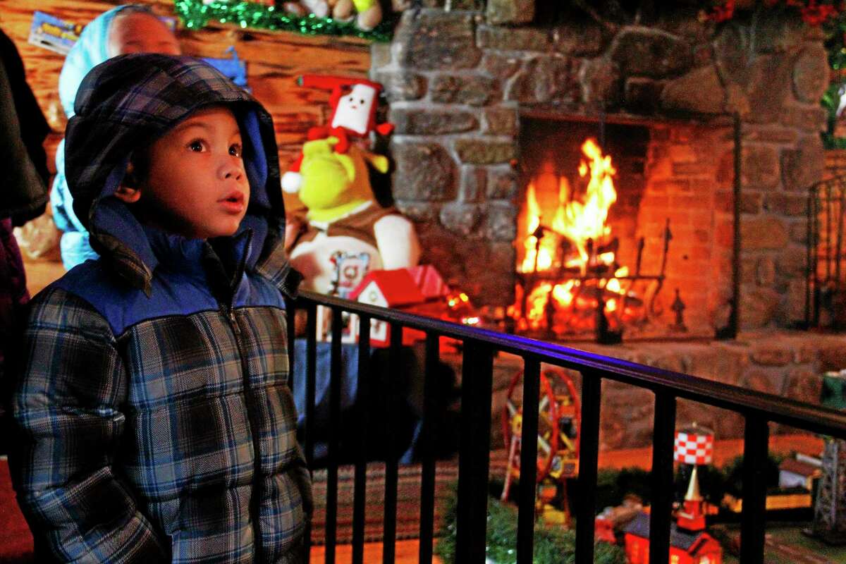 Ethan Santiago, of New Britain, marvels at the toys and decorations inside Santa’s Workshop at Carl Bozenski’s Christmas Village in this 2013 file photo.