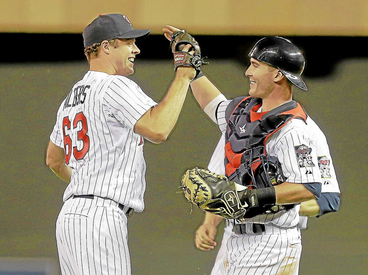 Minnesota Twins catcher Chris Herrmann, right, congratulates Minnesota Twins pitcher Andrew Albers after he sut out the Cleveland Indians 3-0 in a baseball game, Monday, Aug. 12, 2013 in Minneapolis. Albers gave up only two hits to the Indians as he picked up his second win.