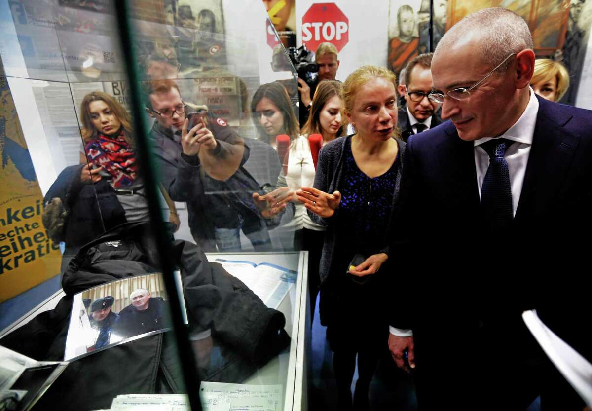 Mikhail Khodorkovsky, right walks through Checkpoint Charlie Museum accompanied by museum director, Alexandra Hildebrandt, front left, as he arrives for a press conference at the museum in Berlin, Sunday Dec. 22, 2013. The former oil baron Mikhail Khodorkovsky was reunited with his family in Berlin on Saturday, a day after being released from a decade-long imprisonment in Russia. AP Photo/dpa,Michael Kappeler