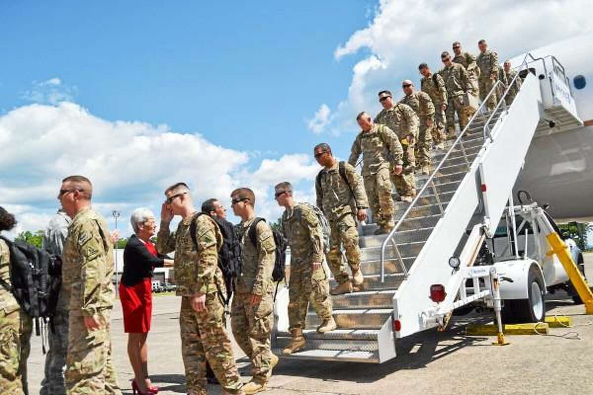 Service men and women of the 1048th Transportation Company of the Connecticut National Guard are greeted in East Granby by Gov. Dannel Malloy and Lt. Gov. Nancy after returning from Afghanistan. (Tom Caprood-Register Citizen)