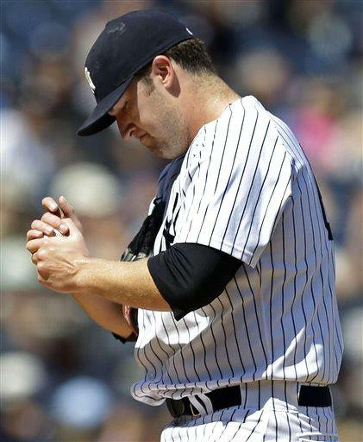 New York Yankees starting pitcher Phil Hughes reacts after allowing a fourth-inning solo home run to Los Angeles Angels' Chris Nelson in a baseball game, Thursday, Aug. 15, 2013, in New York. (AP Photo/Kathy Willens)