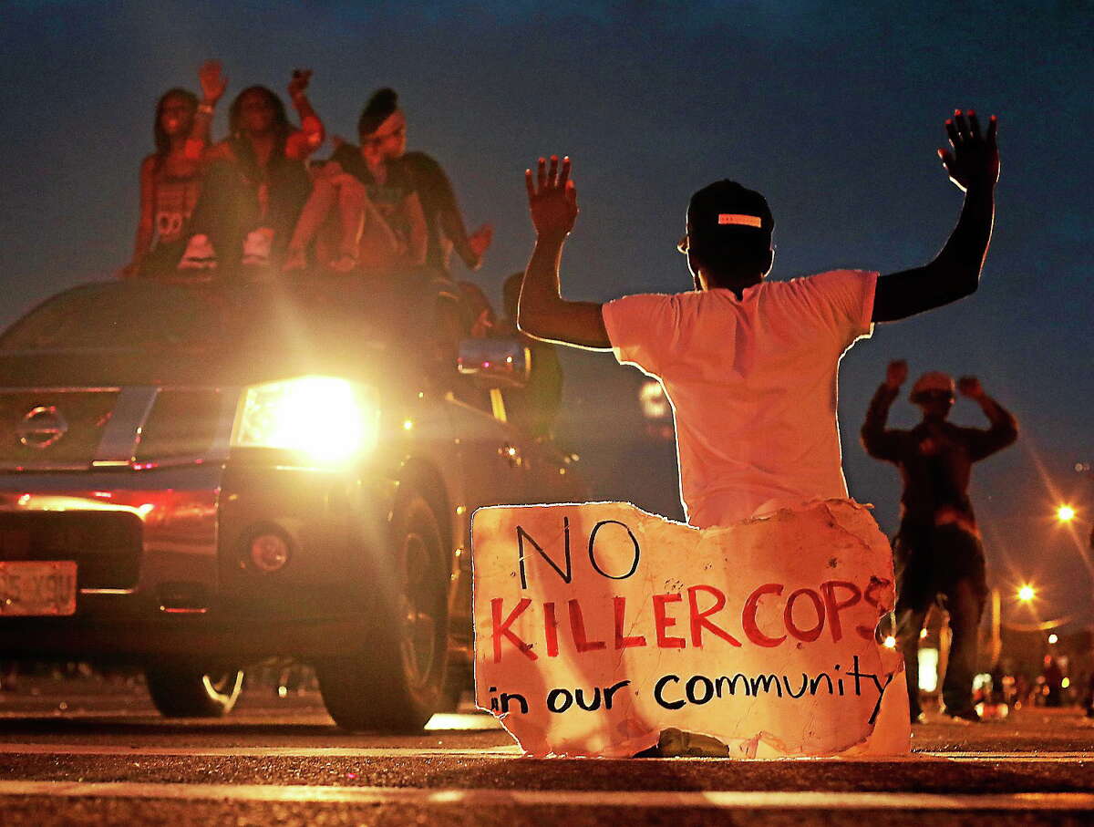 People protest Aug. 17, 2014, for Michael Brown, who was killed by a police officer last Saturday in Ferguson, Mo.
