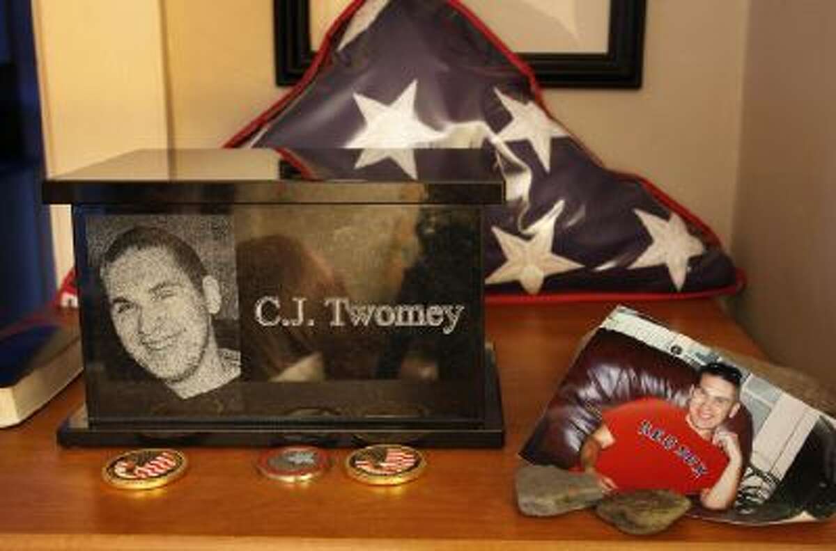 An urn containing the ashes of C.J. Twomey sits on a shelf at his parents' home in Auburn, Maine.