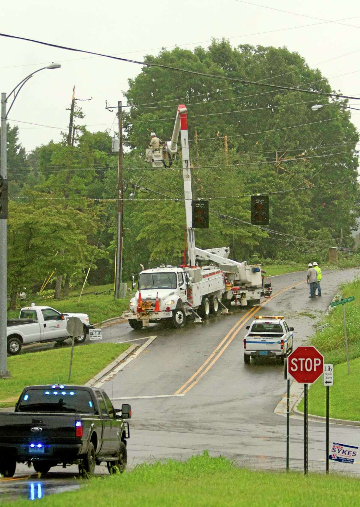 Alabama Power Company crews work on power lines knocked down by a UPS cargo plane which crashed at the Birmingham International airport in Birmingham, Ala. on Wednesday, Aug. 14, 2013. (AP Photo/Butch Dill)