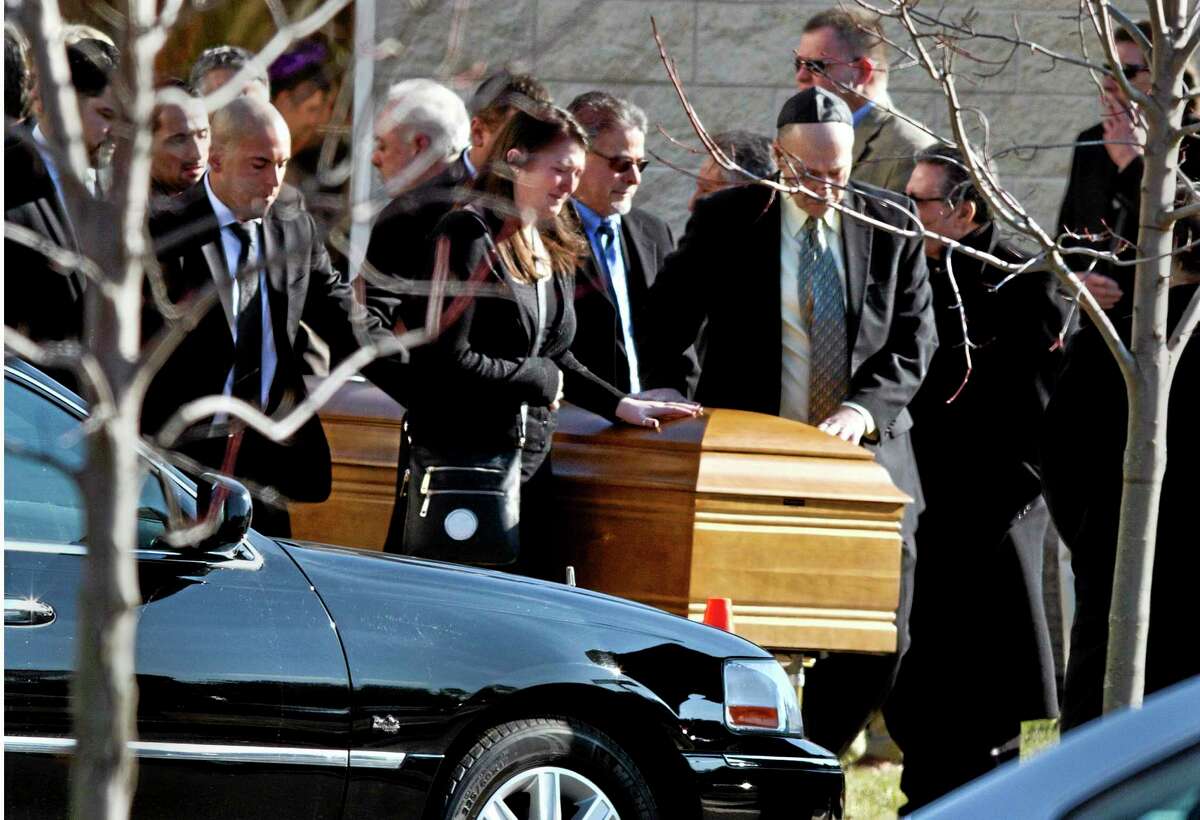 The casket of Dustin Friedland is carried from the temple after a funeral service Wednesday, Dec. 18, 2013,in Lakewood, N.J. Friends and relatives gathered to mourn the 30-year-old lawyer who was shot to death by a carjackers outside a northern New Jersey mall last weekend. (AP Photo/The Asbury Park Press, Doug Hood) NO SALES