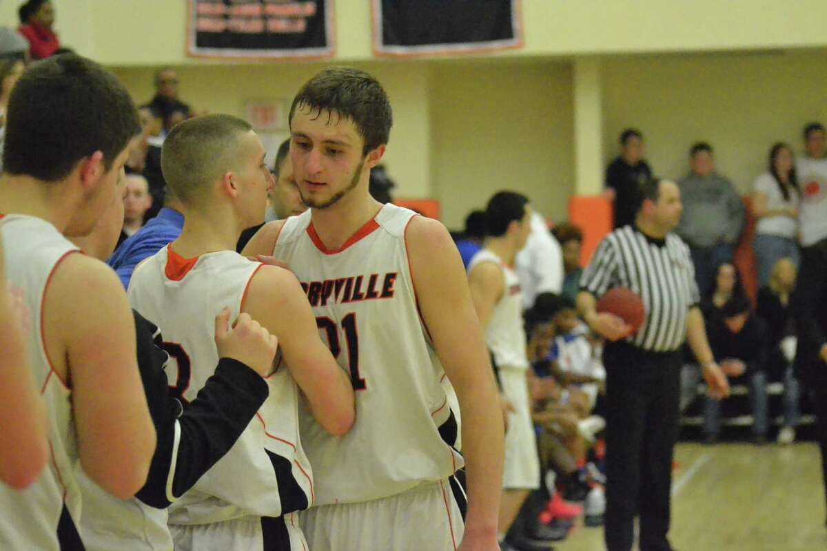 Terryvilleís Tyler Trillo (left) hugs teammates Jacob Johnson (right) after he is taken out of the game for the final time.