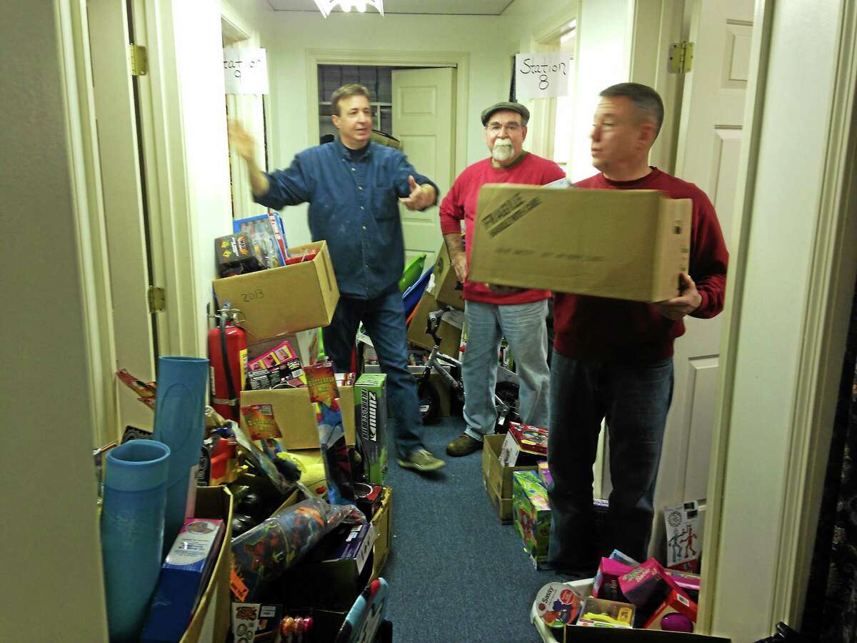 “Elves” from Friendly Hands Food Bank organize gifts to give to local families in the Torrington area.