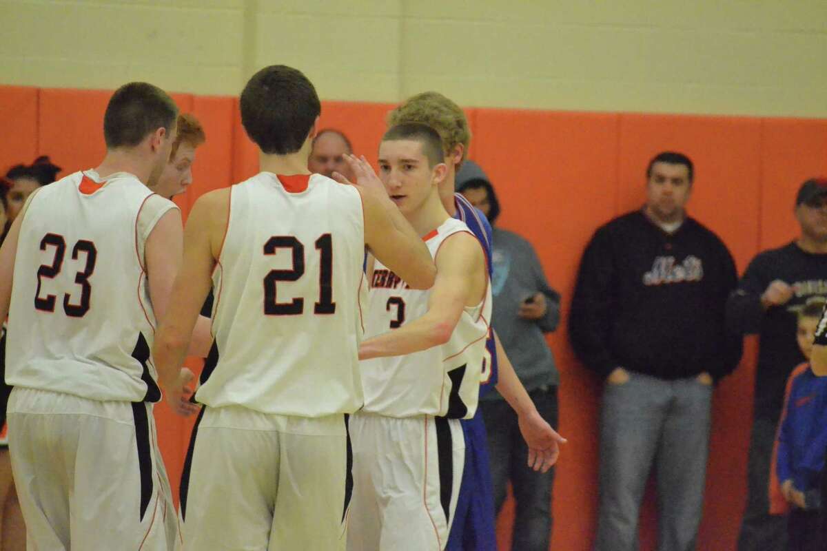 Terryvilleís Jacob Johnson (21) and Tyler Trillo (3) high five during their win against Coginchaug, earlier this season.