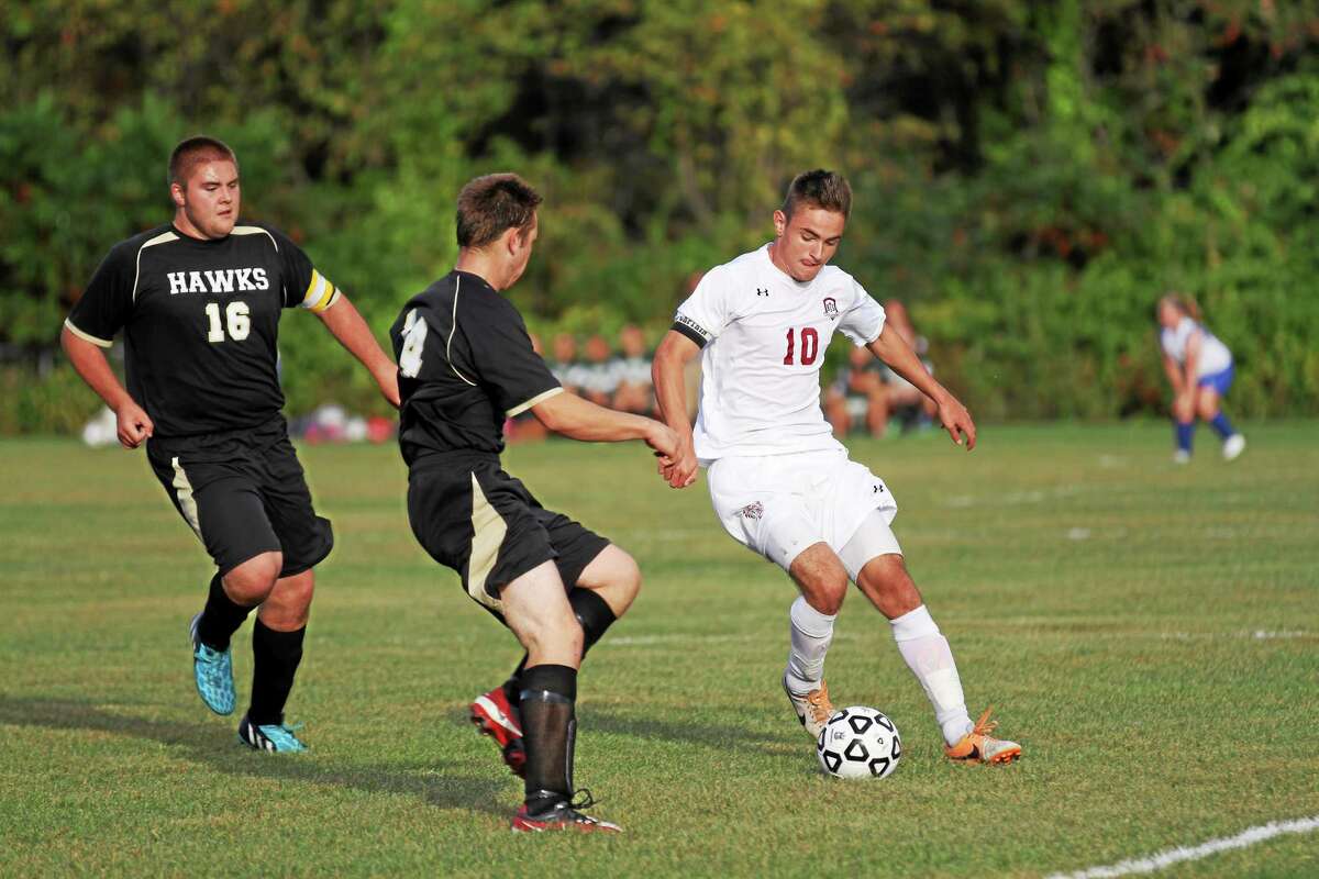 Torrington’s Amar Suljic is defended by two Woodland players during a game earlier this season.