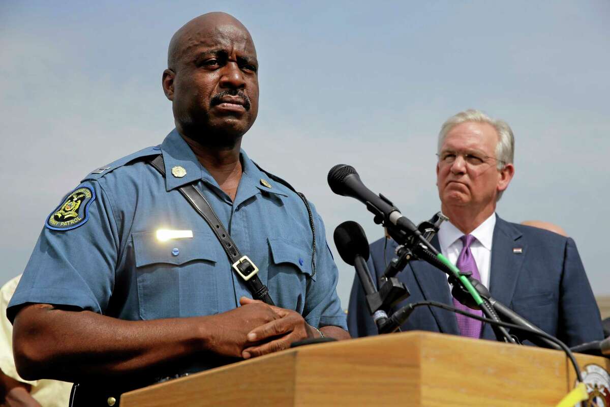 In this Aug. 15, 2014, file photo, Capt. Ron Johnson of the Missouri Highway Patrol, left, and Missouri Gov. Jay Nixon take part in a news conference in Ferguson, Mo. Nixon assigned protest oversight to Johnson after violent protests in Ferguson erupted in the wake of the fatal shooting of Michael Brown by a police officer on Aug. 9.