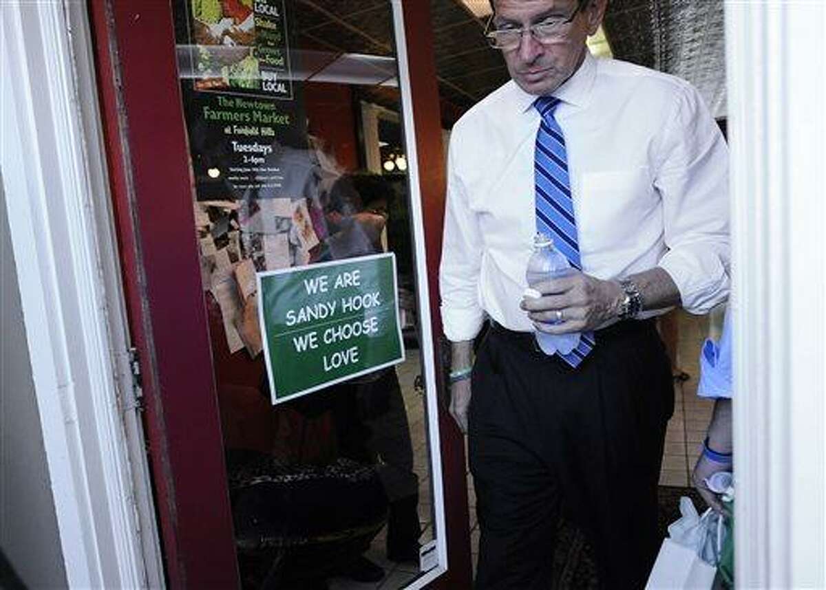 Connecticut Gov. Dannel P. Malloy tours the downtown business district of Sandy Hook in Newtown, Conn., Wednesday, July 31, 2013. Malloy is visiting to meet with business owners and talk about economic recovery after the December elementary school shooting that killed 20 students and six adults. (AP Photo/Jessica Hill)