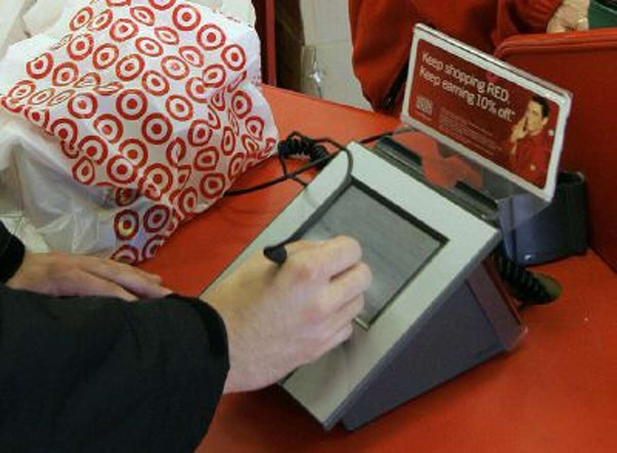 A customer signs his credit card receipt at a Target store in Tallahassee, Fla., in January 2008.
