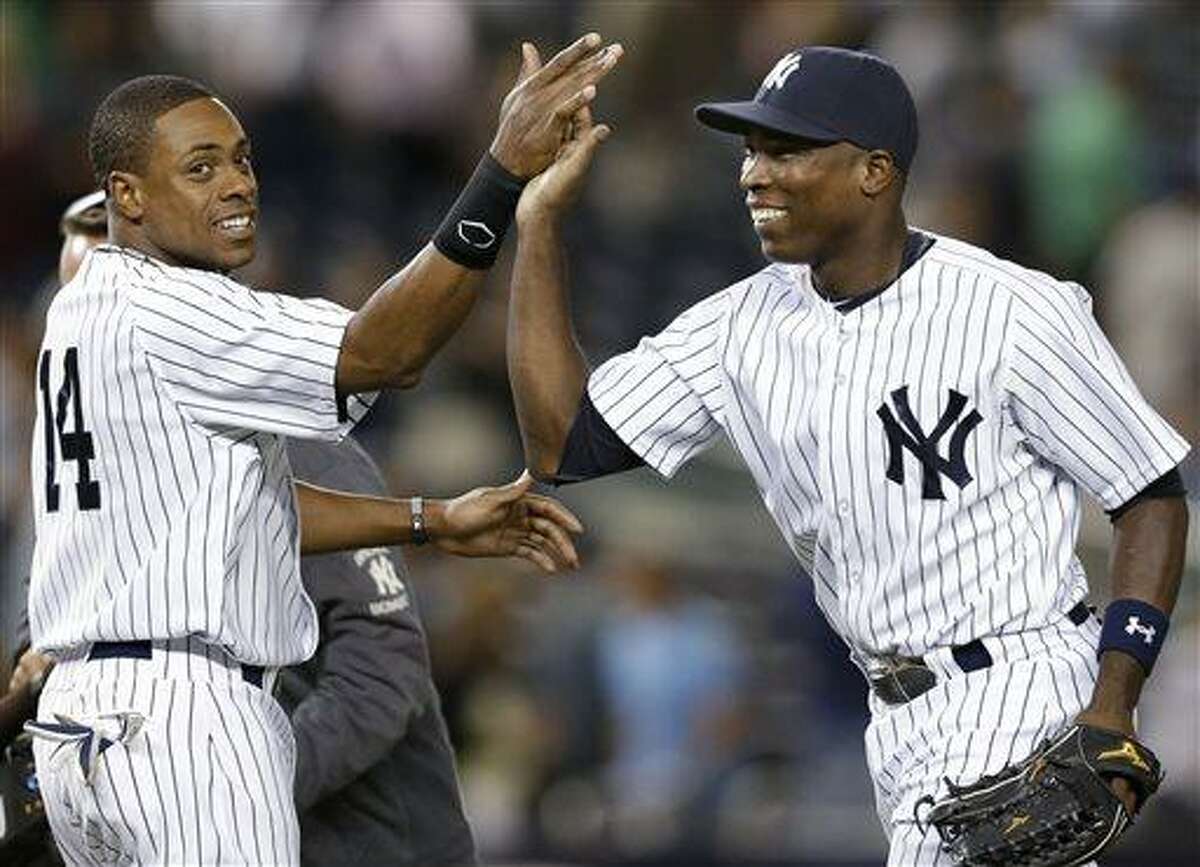 New York Yankees right fielder Curtis Granderson, left, congratulates left fielder Alfonso Soriano after the Yankees' 11-3 victory over the Los Angeles Angels in a baseball game Wednesday, Aug. 14, 2013, in New York. (AP Photo/Kathy Willens)