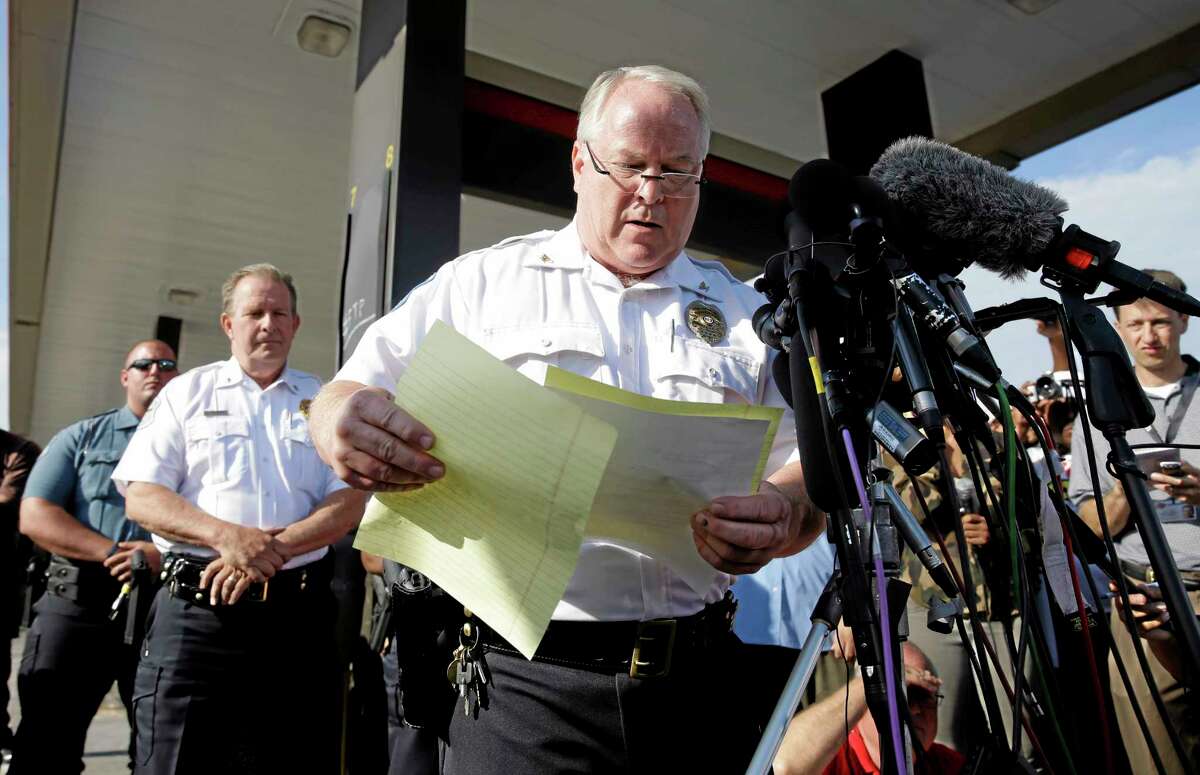 Ferguson Police Chief Thomas Jackson releases the name of the the officer accused of fatally shooting an unarmed black teenager Friday, Aug. 15, 2014, in Ferguson, Mo. Jackson announced that the officer's name is Darren Wilson. (AP Photo/Jeff Roberson)