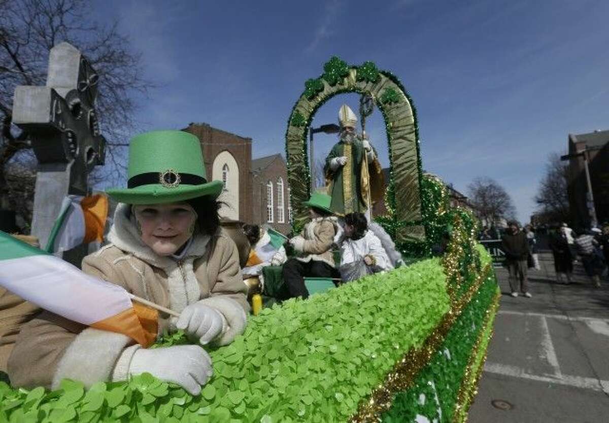 A girl holds an Irish flag while in costume on a float in the St. Patrick's Day Parade, in Boston, March 17, 2013. The parade may lift a 20-year ban on gay organizations this year. (Steven Senne, AP)