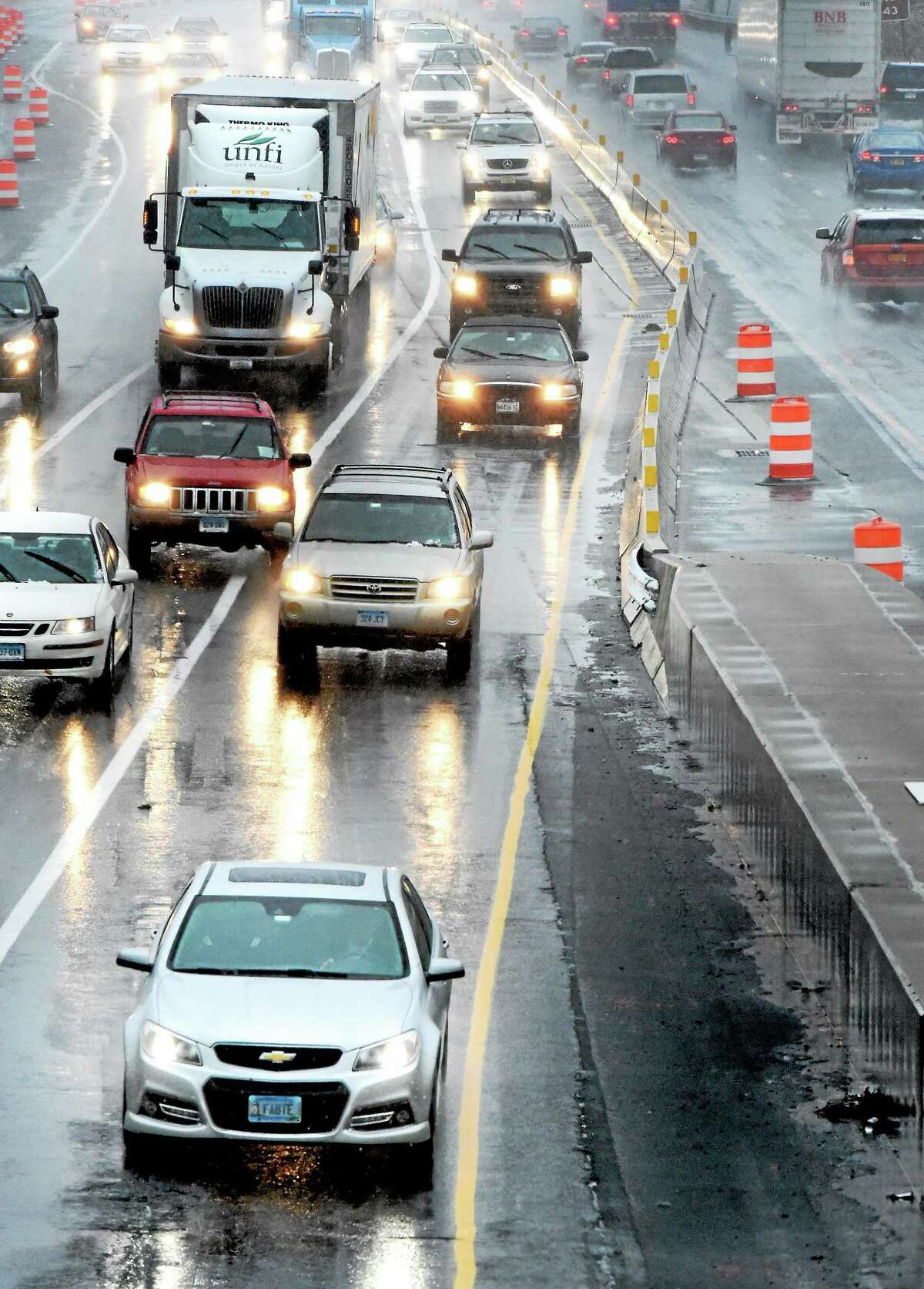 Cars drive through mixed precipitation of rain and slush on I-95 North from West Haven into New Haven Wednesday, November 26, 2014.