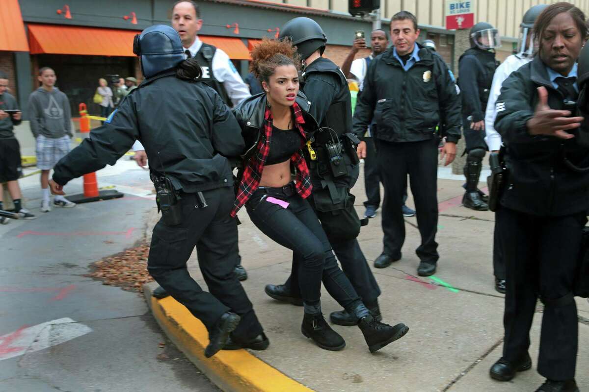 Police arrest a protester on Sunday at Kiener Plaza in St. Louis. Protesters and police clashed following an NFL football game between the St. Louis Rams and the Oakland Raiders as protests continued following a grand jury’s decision not to indict a Ferguson police officer in the shooting death of Michael Brown.