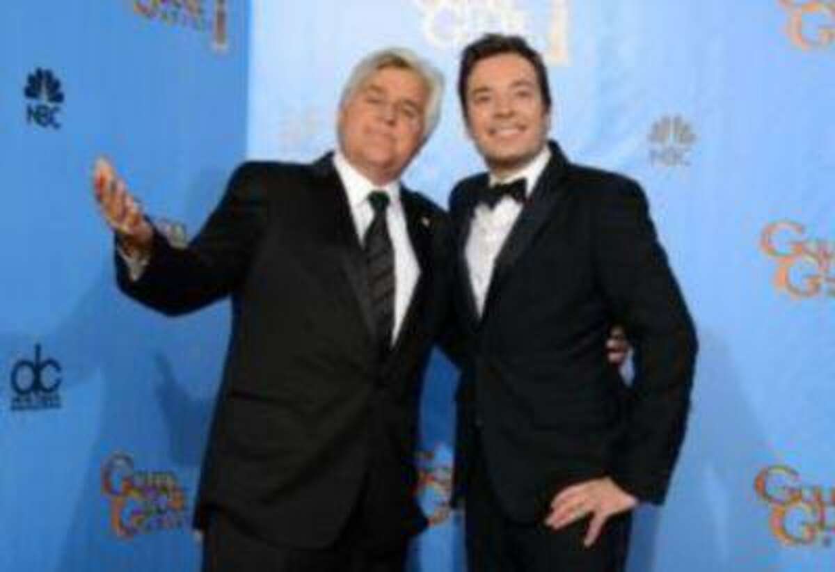This Jan. 13, 2013 photo shows Jay Leno, host of "The Tonight Show with Jay Leno," left, and Jimmy Fallon, host of "Late Night with Jimmy Fallon" backstage at the 70th Annual Golden Globe Awards in Beverly Hills.