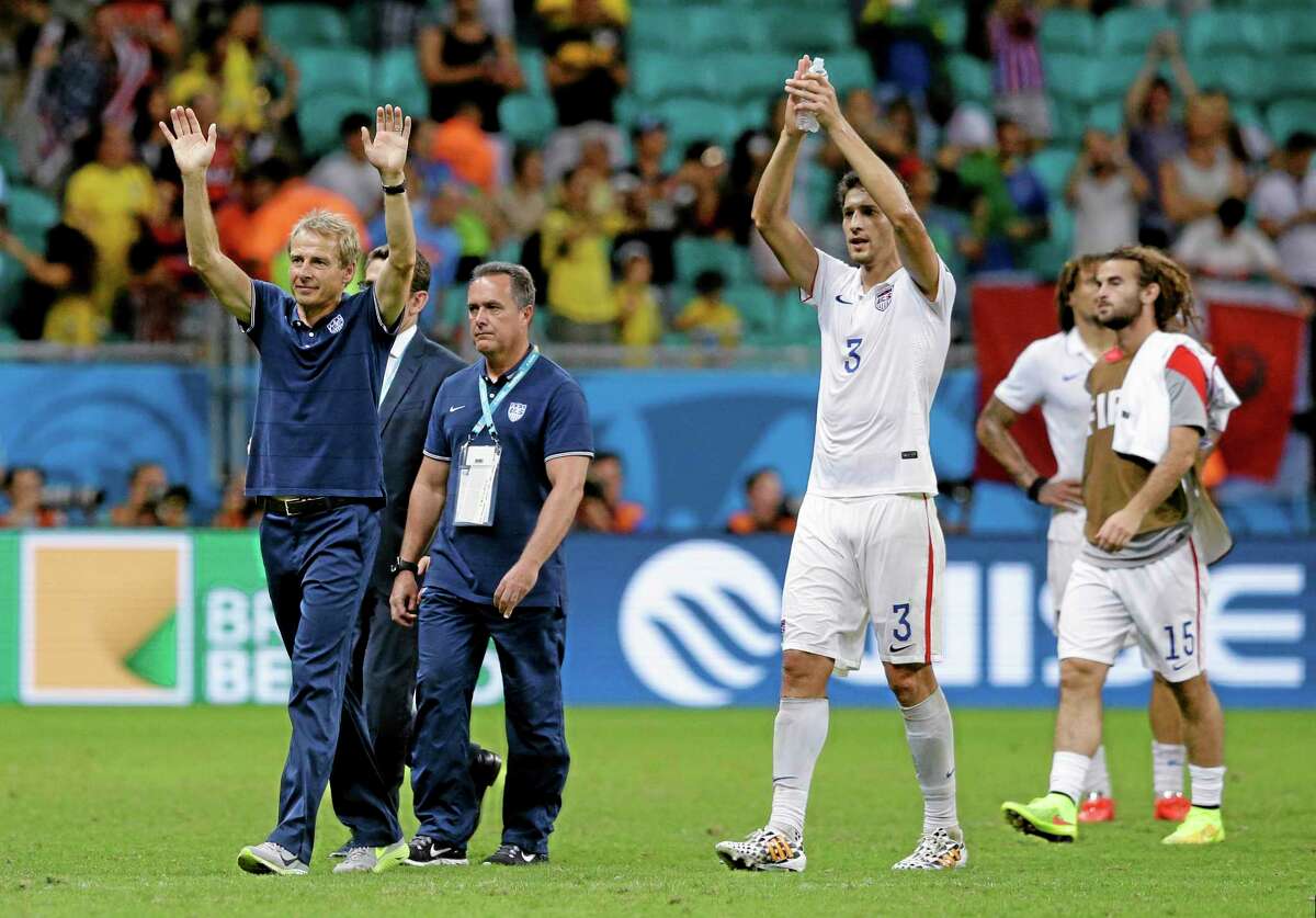 United States head coach Jurgen Klinsmann greets spectators after the World Cup round of 16 match against Belgium on July 1 in Salvador, Brazil.