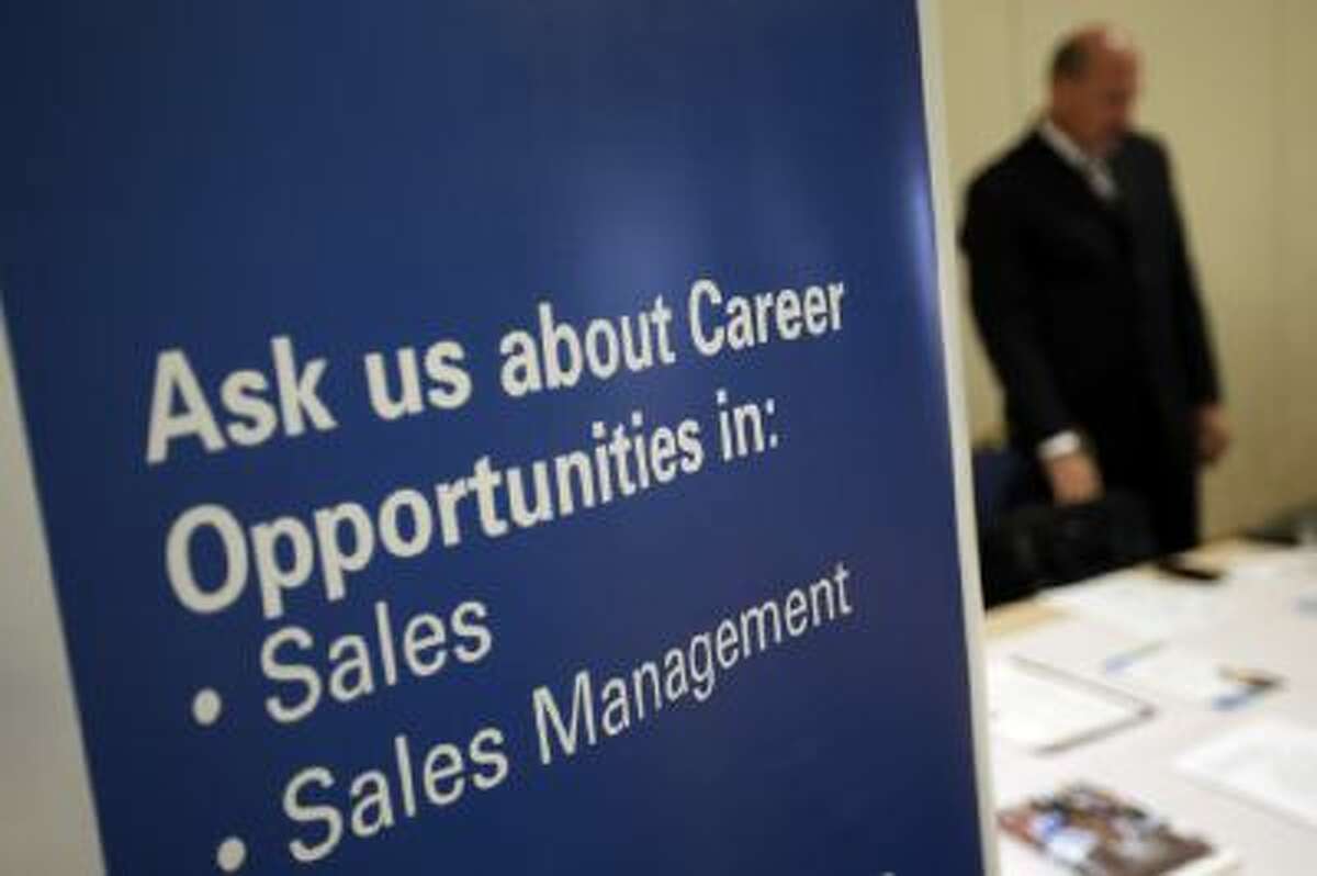 A recruiter waits to meet with job seekers at a career fair in Pennsylvania, June 2013.