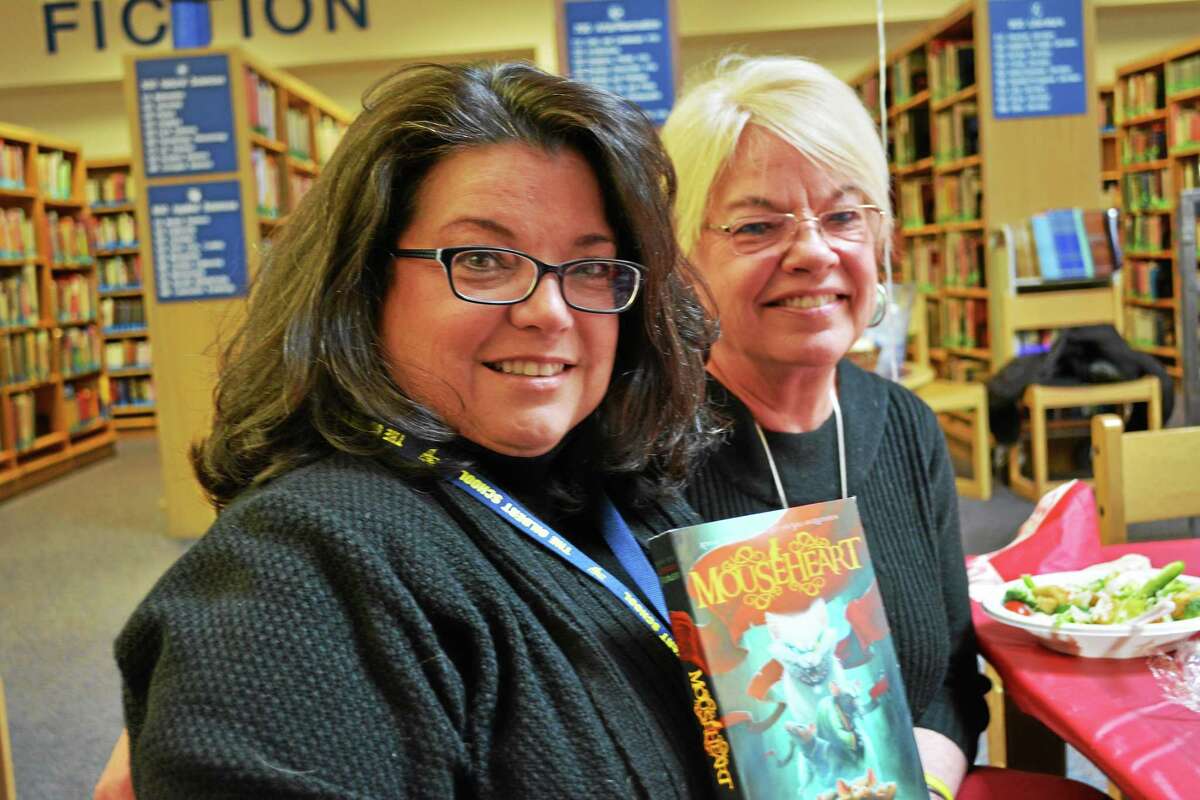 Lisa Fiedler (left) was invited to show her new book, “Mouseheart,” to students by Gilbert teacher Cheryl Caneschi.