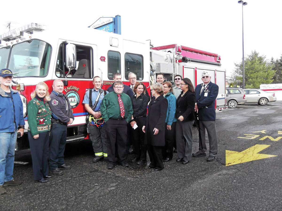 Representatives from McDonald’s, FISH, Susan B. Anthony, AMVETS, and the Torrington Fire Department and the Mayor of Torrington gather at McDonald’s to receive the donations from the company’s Holiday Fundraiser.