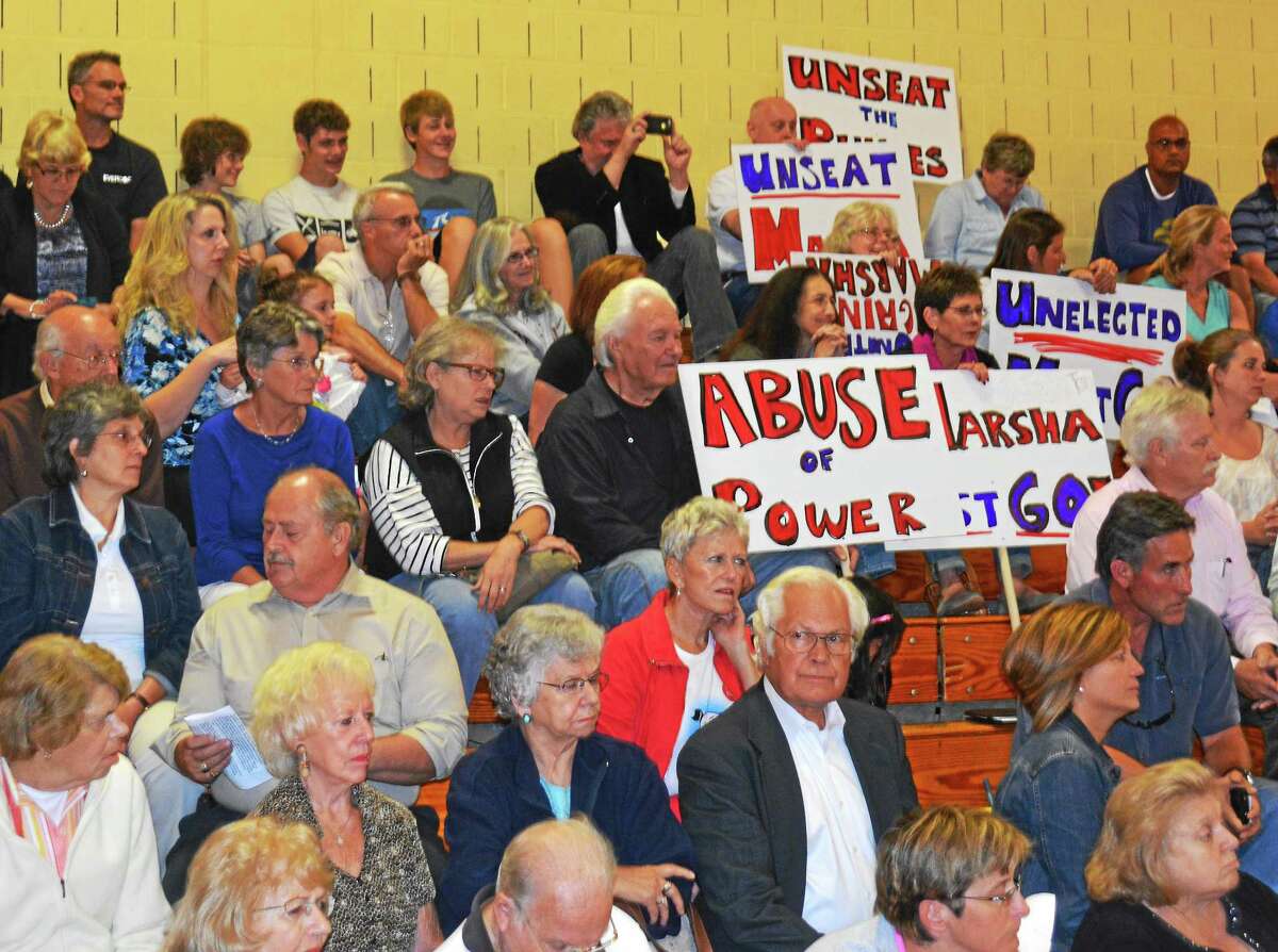 A raucous crowd greeted the Winsted Board of Selectmen Thursday night in the Pearson School Gymnasium prior to a vote to suspend Town Manager Dale Martin with the intention of removing him from office in 30 days.