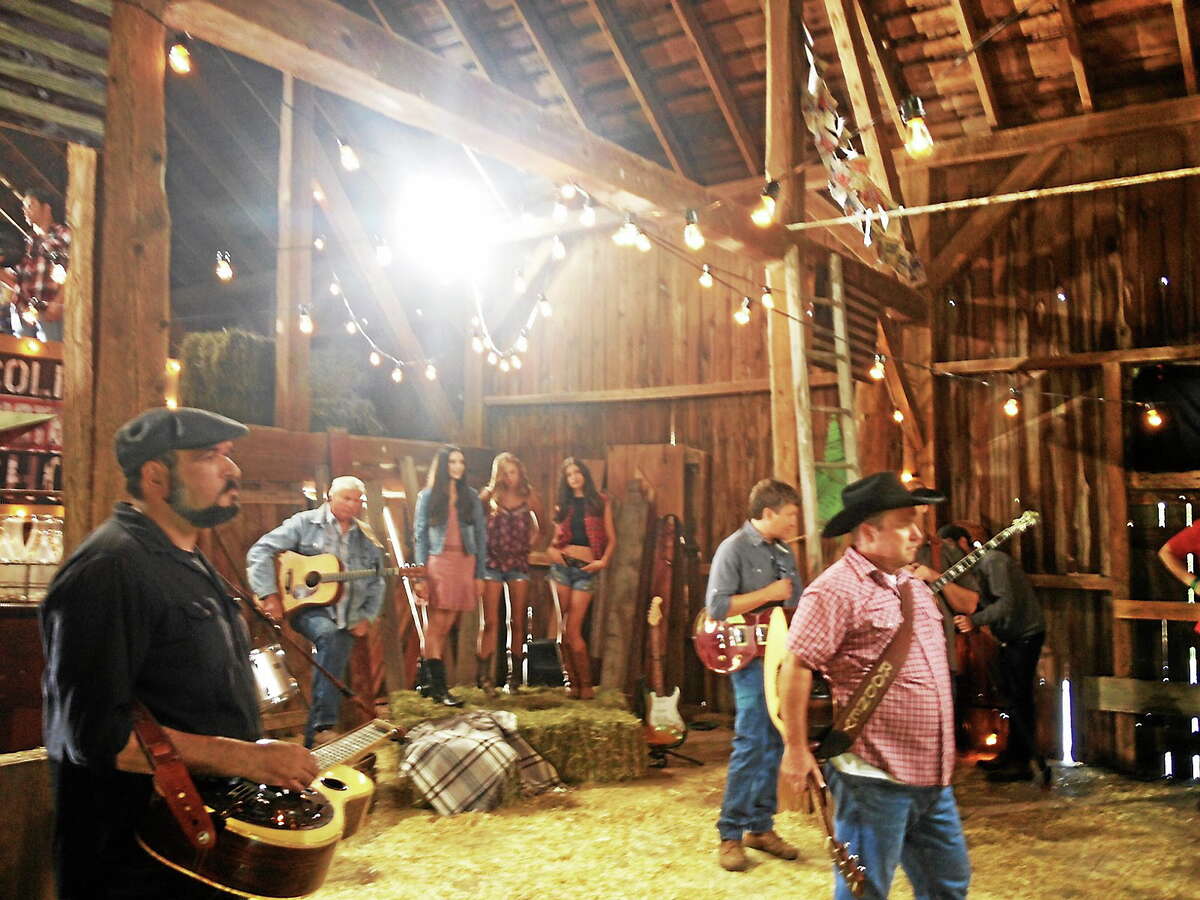 Douglas P. Clement — Connecticut Magazine Rodney Carrington, right, in the barn at The Inn at Mount Pleasant Thursday, joined by other musicians, dancers and the filming crew, shooting different takes of an original song professionally recorded by Carrington Tuesday in Nashville.