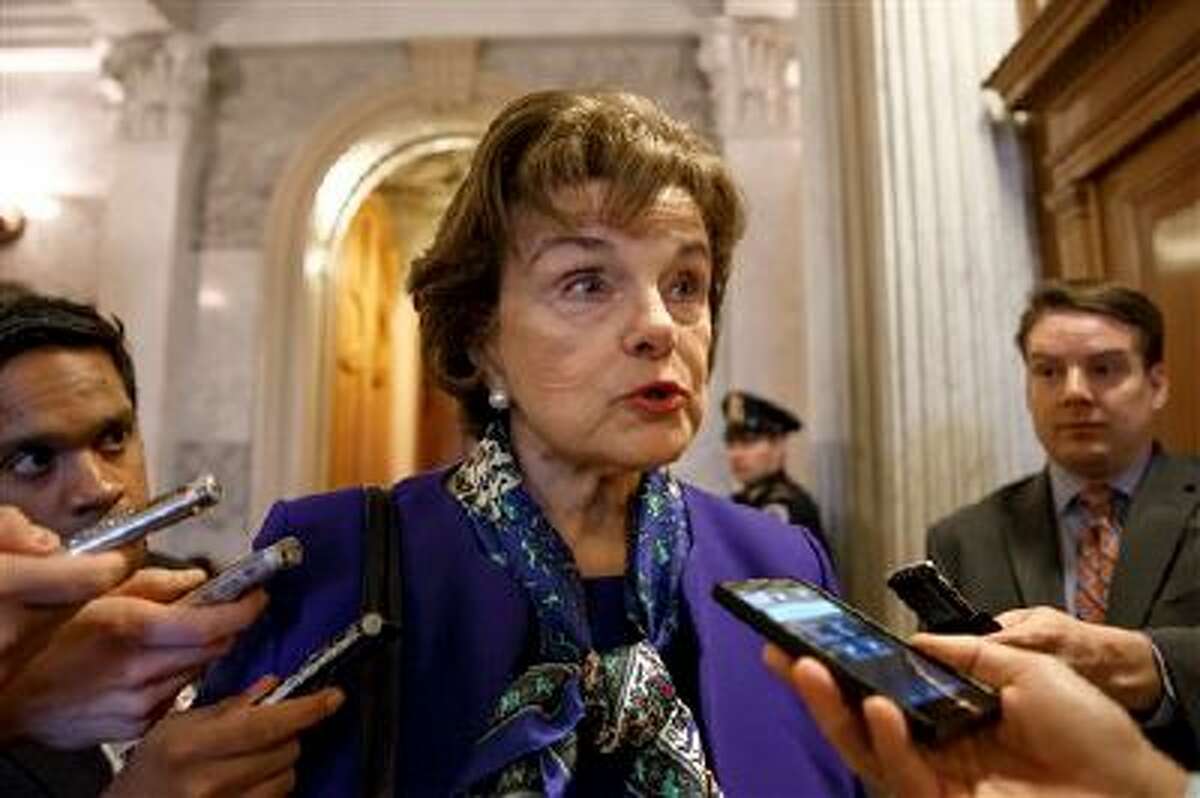Senate Intelligence Committee Chair Sen. Dianne Feinstein, D-Calif. talks to reporters as she leaves the Senate chamber on Capitol Hill in Washington, Tuesday, March 11, 2014, after saying that the CIA's improper search of a stand-alone computer network established for Congress has been referred to the Justice Department. The issue stems from the investigation into allegations of CIA abuse in a Bush-era detention and interrogation program. (AP Photo/J. Scott Applewhite)