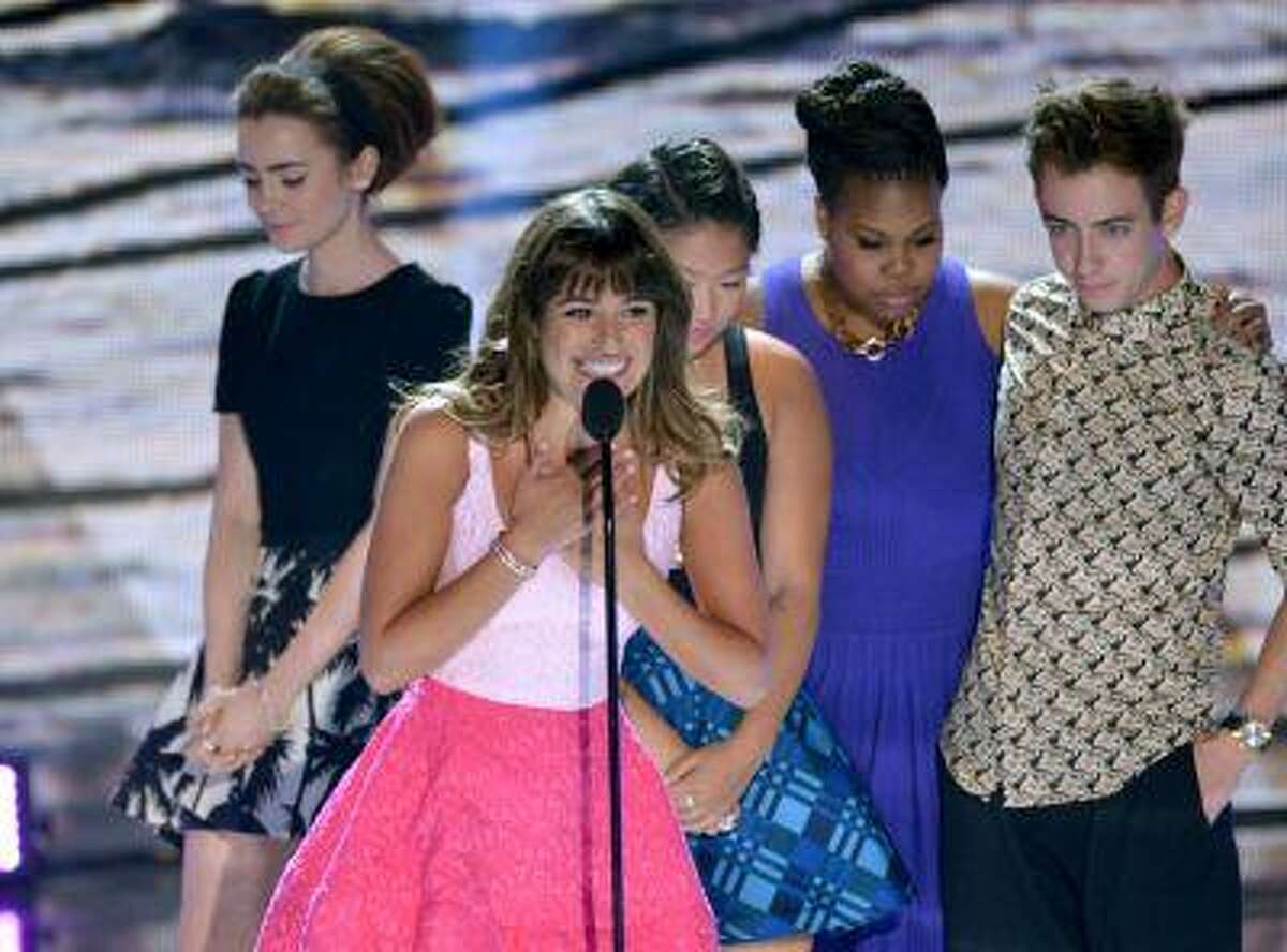 Actress Lea Michele, center, from "Glee"speaks on stage as she accepts an award at the Teen Choice Awards at the Gibson Amphitheater on Sunday, Aug. 11, 2013, in Los Angeles. Pictured in background are fellow cast members, from right, Kevin McHale, Amber Riley, Jenna Ushkowitz and presenter Lily Collins.