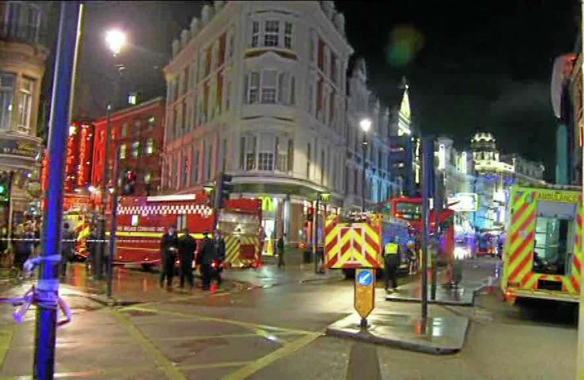 This image taken from television shows emergency services attending an incident at the Apollo Theatre, illuminated at rear right, in London's Shaftesbury Avenue, Thursday evening, Dec. 19, 2013, during a performance at the height of the Christmas season, with police saying there were "a number" of casualties. It wasn't immediately clear if the roof, ceiling or balcony collapsed during a performance. Police said they "are aware of a number of casualties," but had no further details. (AP Photo/Sky News) UNITED KINGDOM OUT, TV OUT
